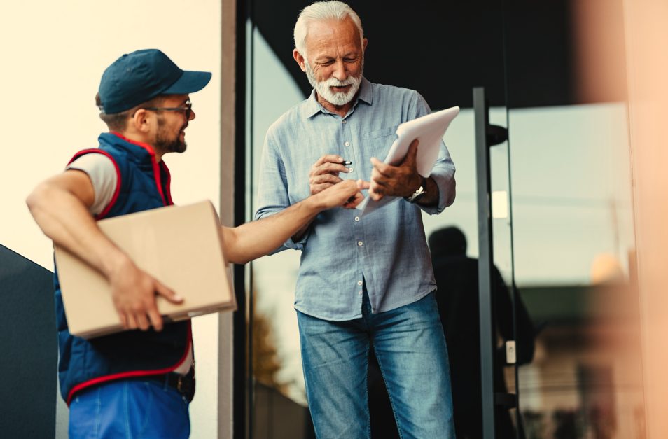 NuWay Relocation | Senior Moving Services: From Downsizing to Settling Into a New Home Movers helping a senior couple settle into their new home